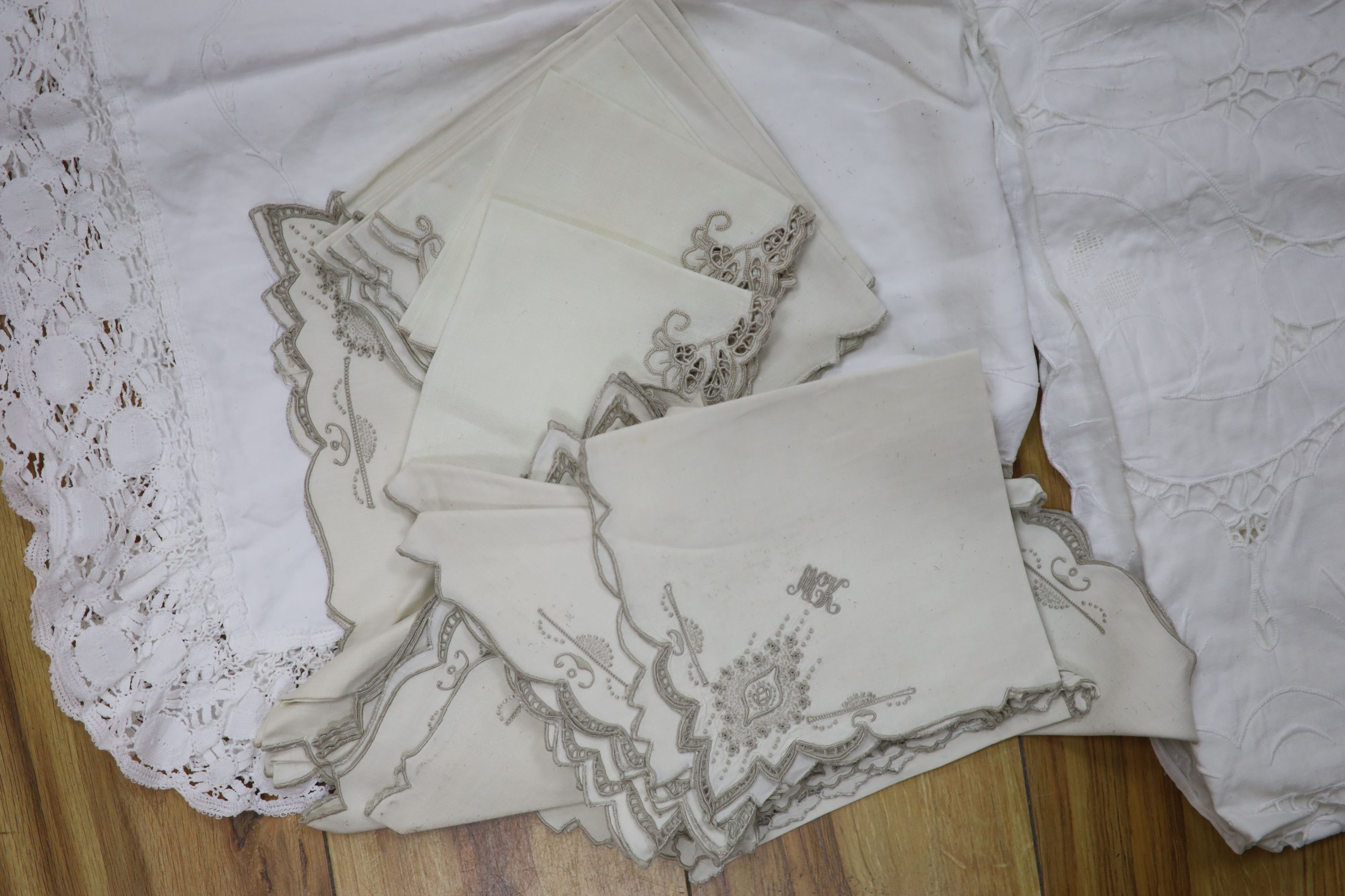 A large cutwork tablecloth, pillowcase plus a napkin and table mat set